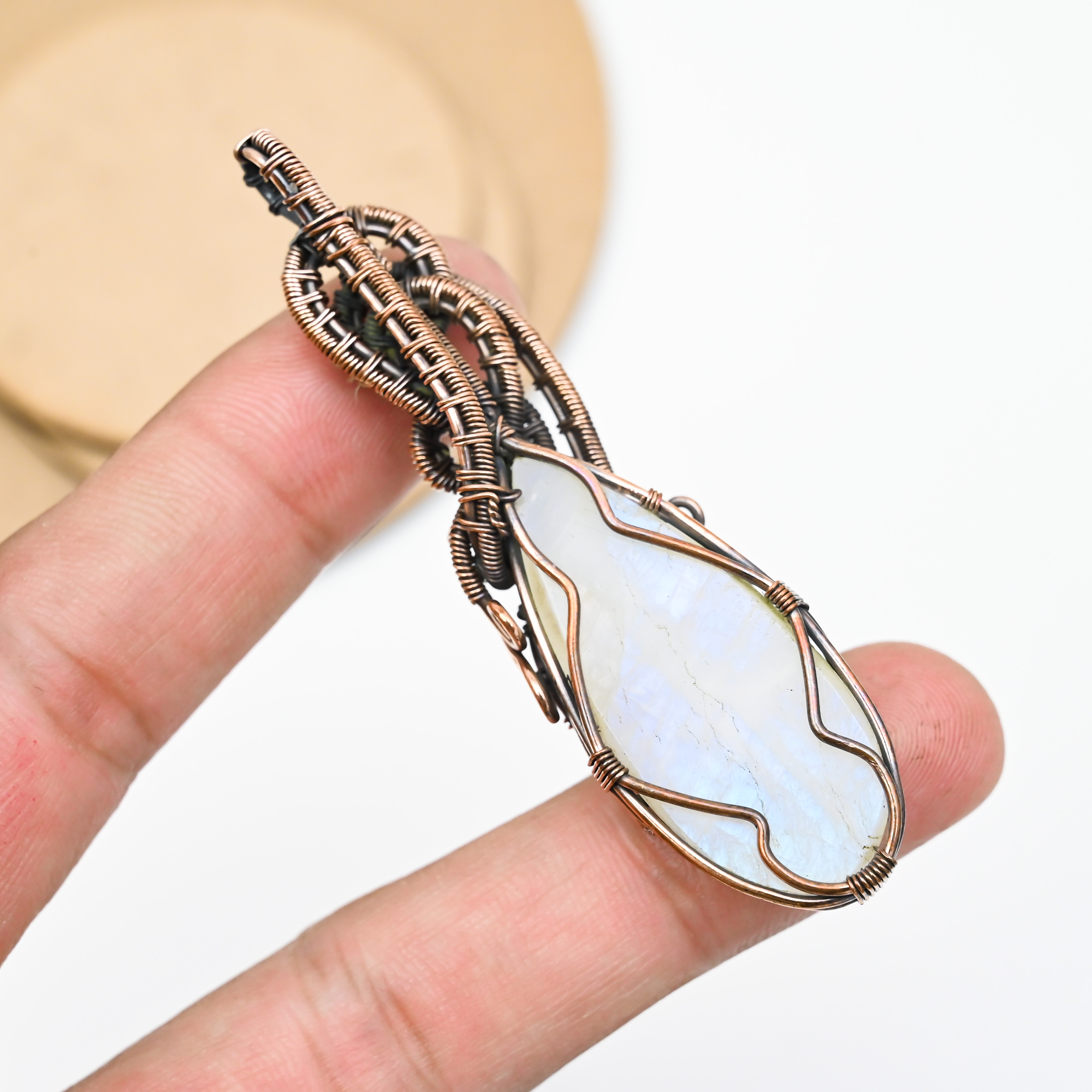 Handmade moonstone pendant wrapped in copper wire