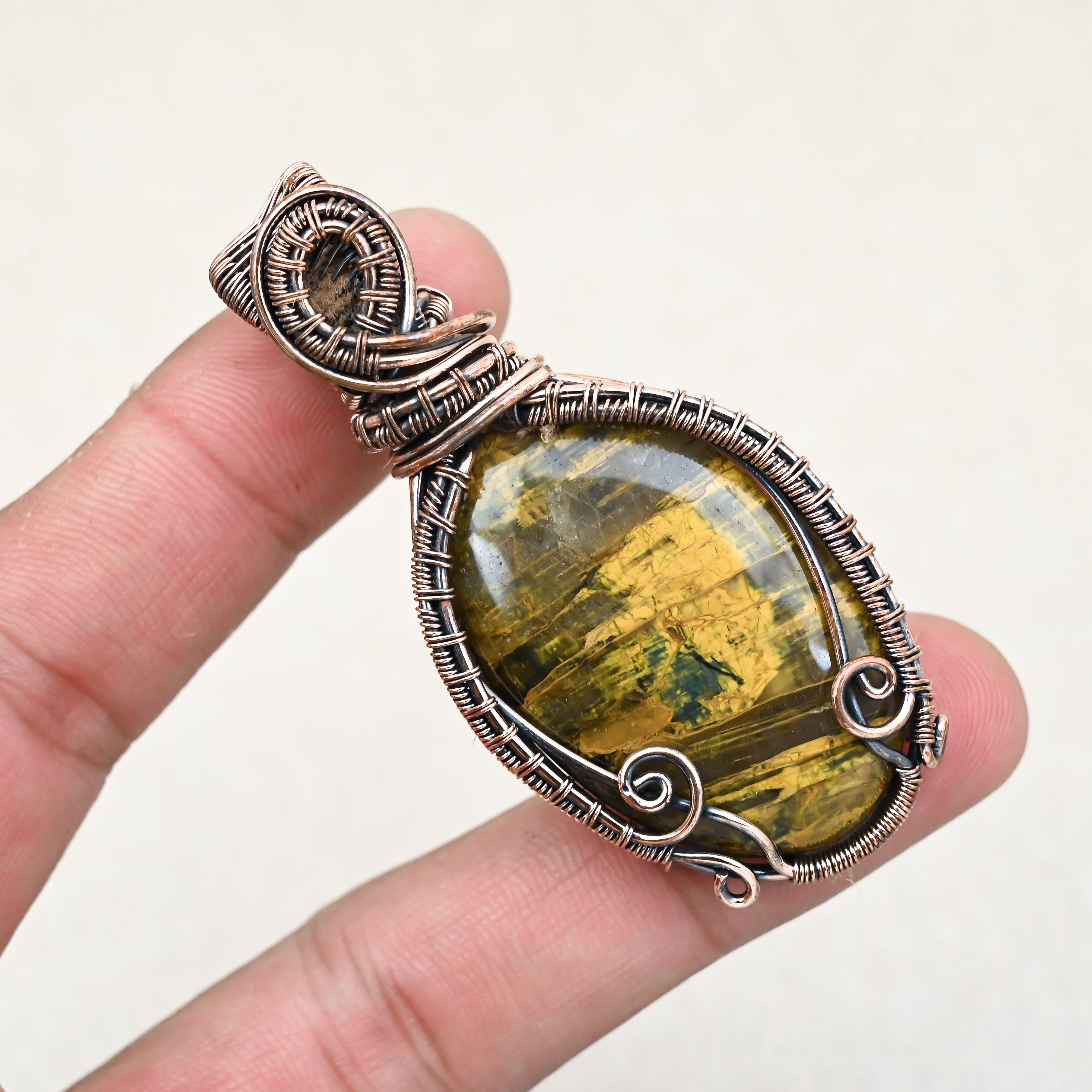 Natural Tiger Eye crystal pendant with copper wire wrap