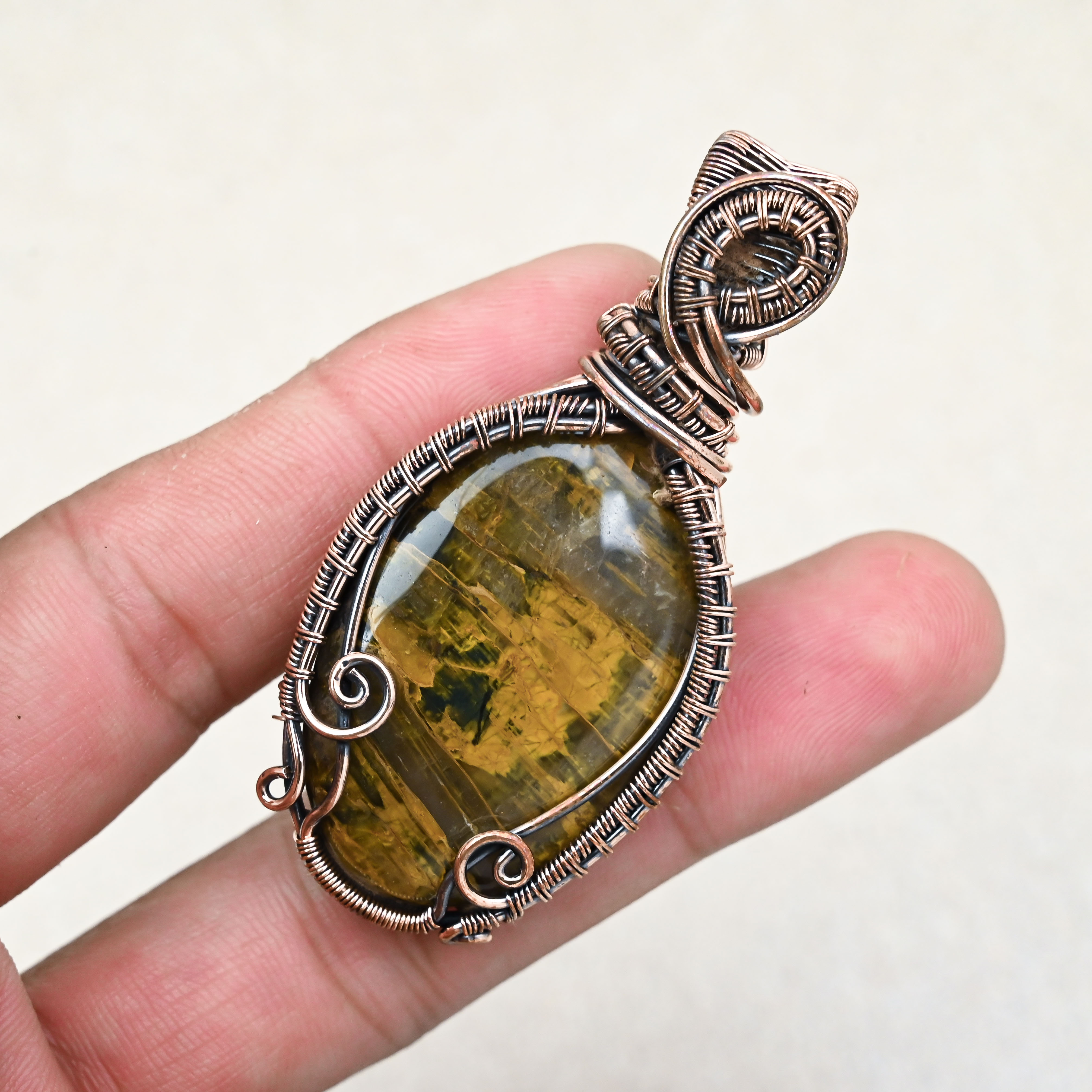Natural Tiger Eye crystal pendant with copper wire wrap